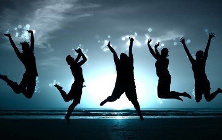 Image - Three people jumping and sunset