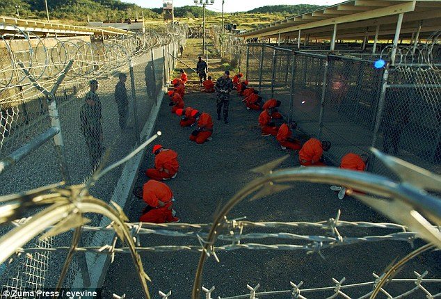 Photo - Taliban and al-Qaida suspects in orange jumpsuits at Guantanamo Bay prison complex [Credit: Zuma press/eyevine]