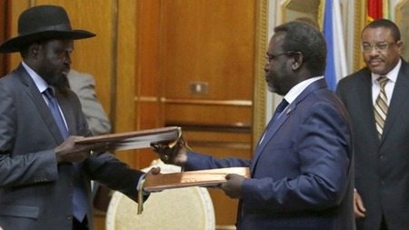 President Salva Kiir and rebel leader Riek Machar and Ethiopian PM Hailemariam Desalegn - at the peace deal signing in Addis Ababa