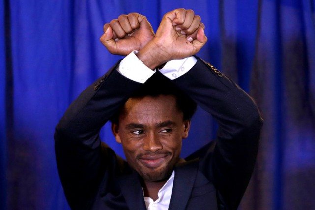 Photo - Olympian Feyisa Lilesa making Oromo protest gesture in Washington, DC [Credit: Reuters]